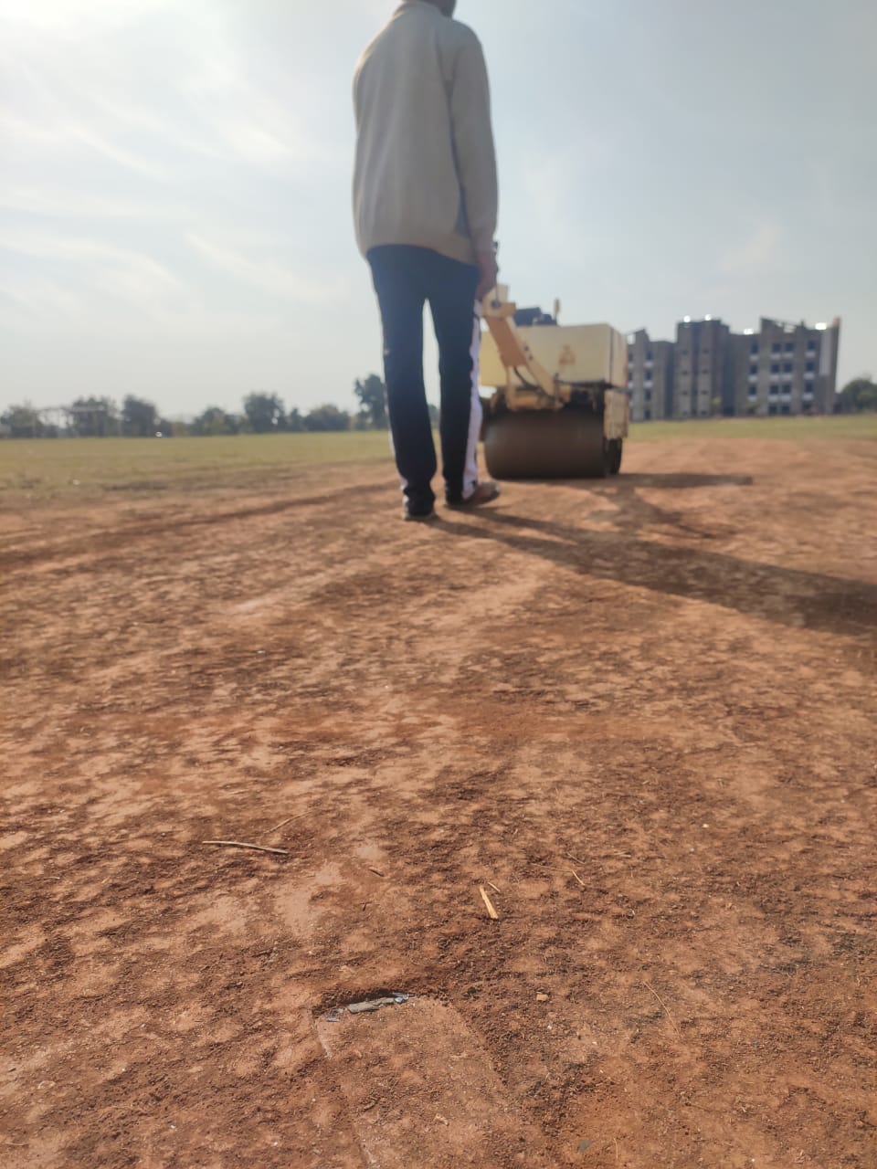 Sahil running the roller on the pitch
